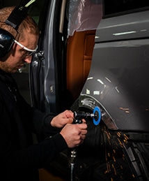 Employé utilise un outil sur voiture